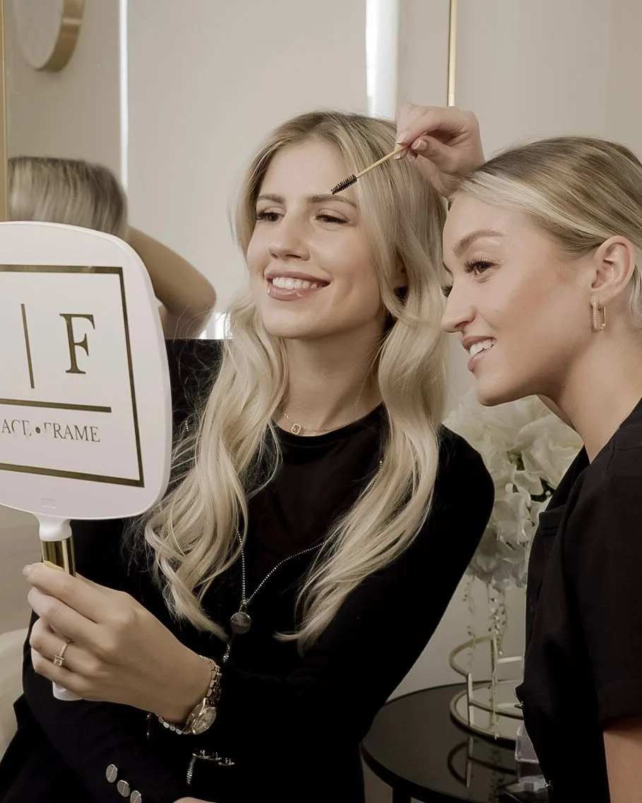 Iggy perfecting a client’s brows at the FaceFrame Beauty studio